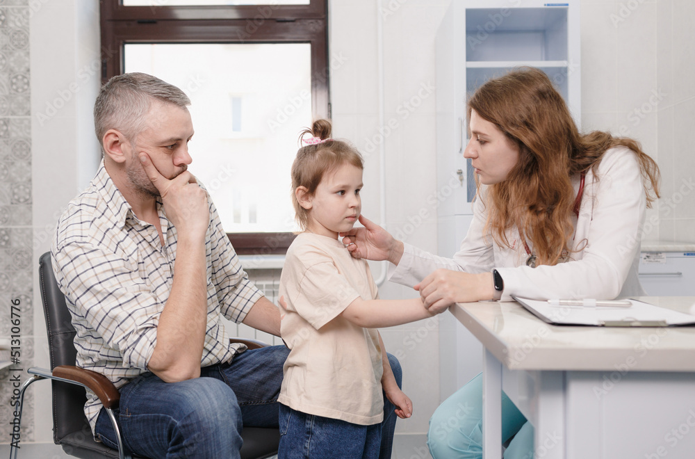 Fototapeta premium a female pediatrician examines a little girl during an appointment in a medical office. family doctor. insurance medicine