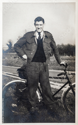 Young man out for a bike ride. Vintage photo of a teenager, approx aged 18, with push bike, circa 1944