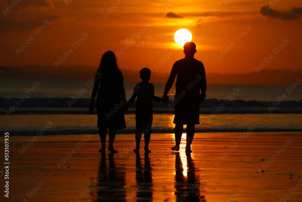 family in sunset at beach