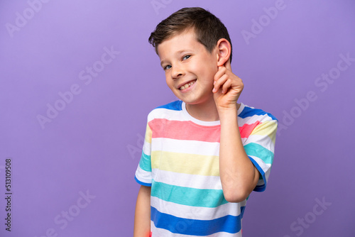 Little boy isolated on purple background laughing