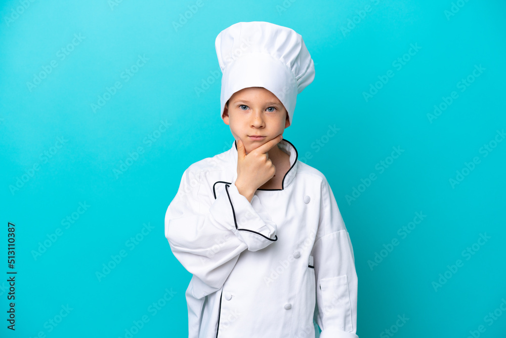 Little chef boy isolated on blue background thinking Little chef boy isolated on blue background thinking