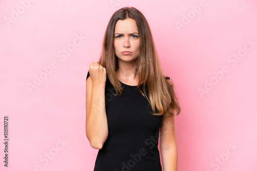 Young caucasian woman isolated on pink background with unhappy expression