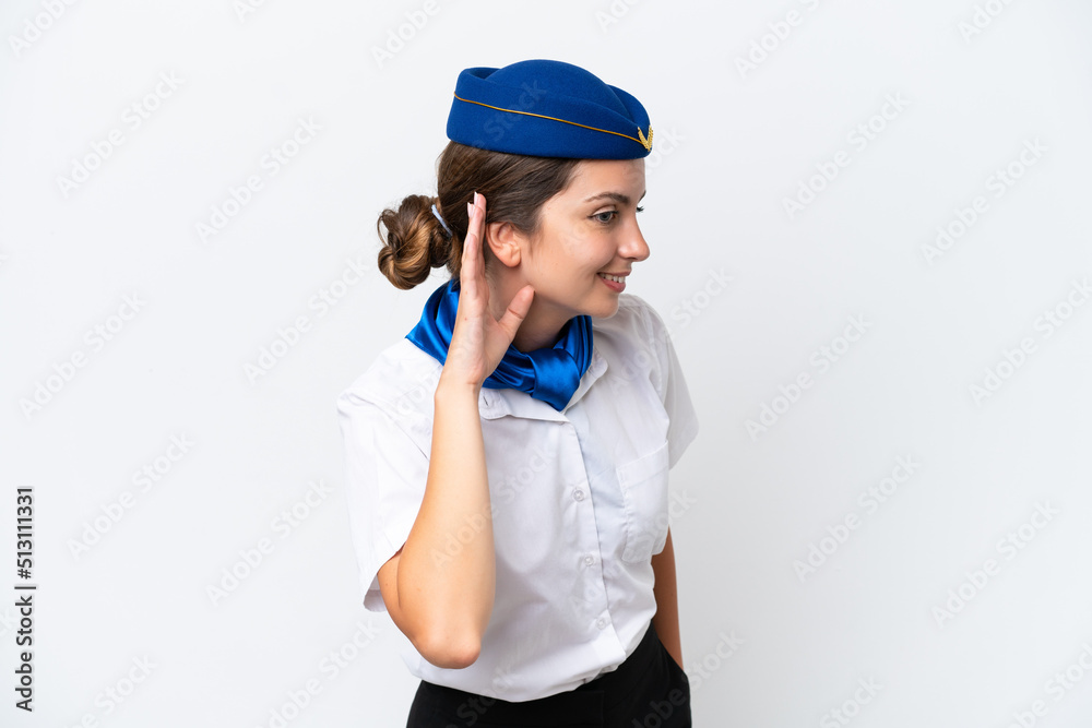 Airplane stewardess caucasian woman isolated on white background listening to something by putting hand on the ear Airplane stewardess caucasian woman isolated on white background listening to something by putting hand on the ear