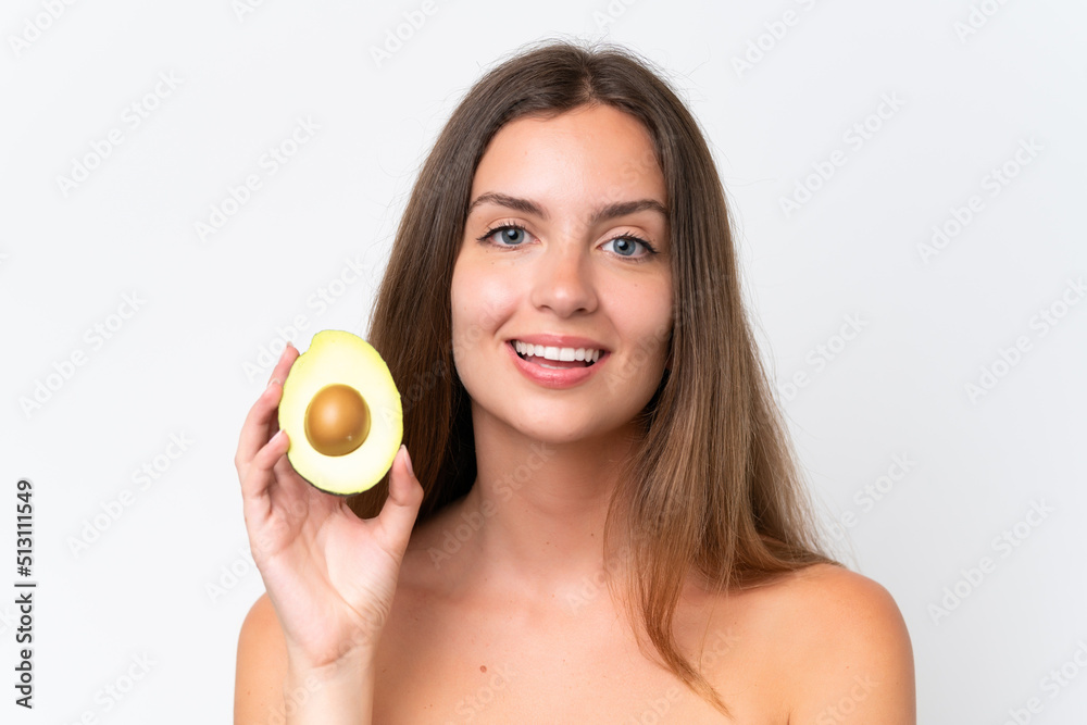 Young caucasian woman isolated on white background holding an avocado while smiling. Close up portrait Young caucasian woman isolated on white background holding an avocado while smiling. Close up portrait