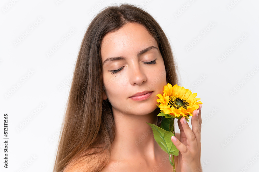 Young caucasian woman isolated on white background holding a sunflower. Close up portrait Young caucasian woman isolated on white background holding a sunflower. Close up portrait
