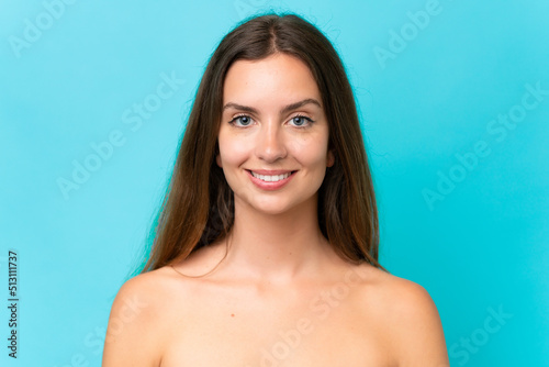 Young caucasian woman isolated on blue background . Portrait