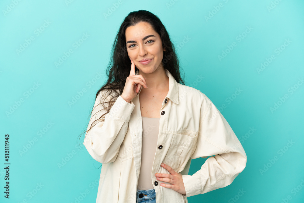 Young caucasian woman isolated on blue background and thinking Young caucasian woman isolated on blue background and thinking