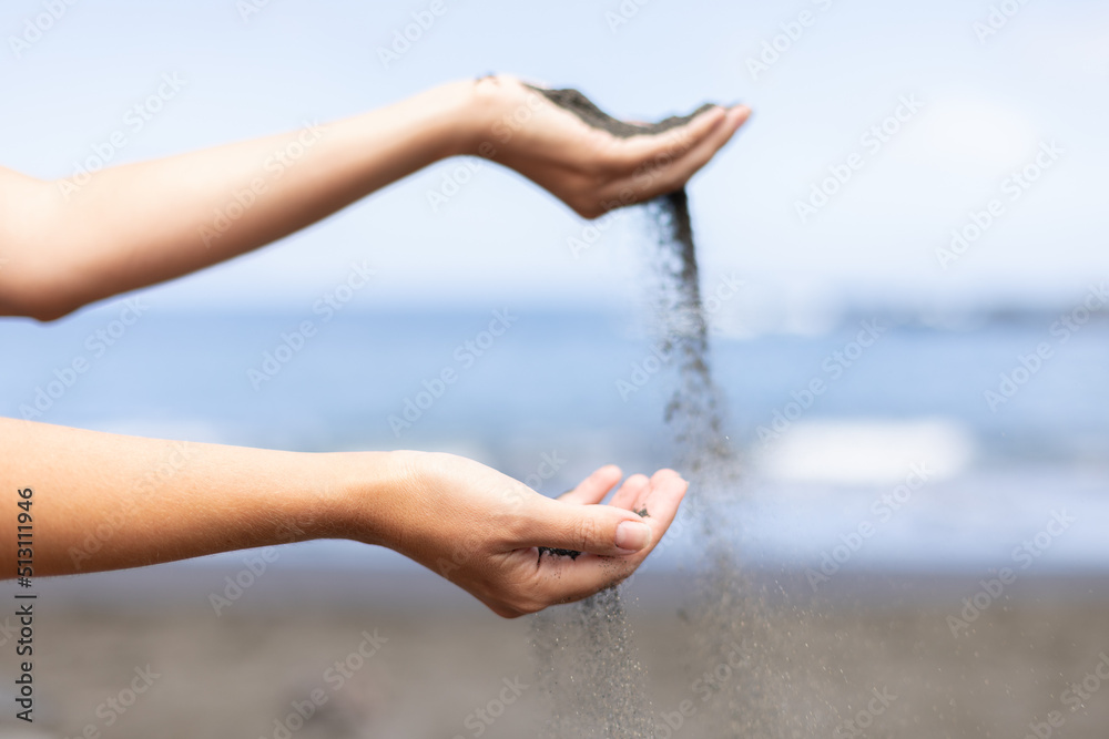 Female hands playing with sand. Summer holidays and vacation concept. Close up.
