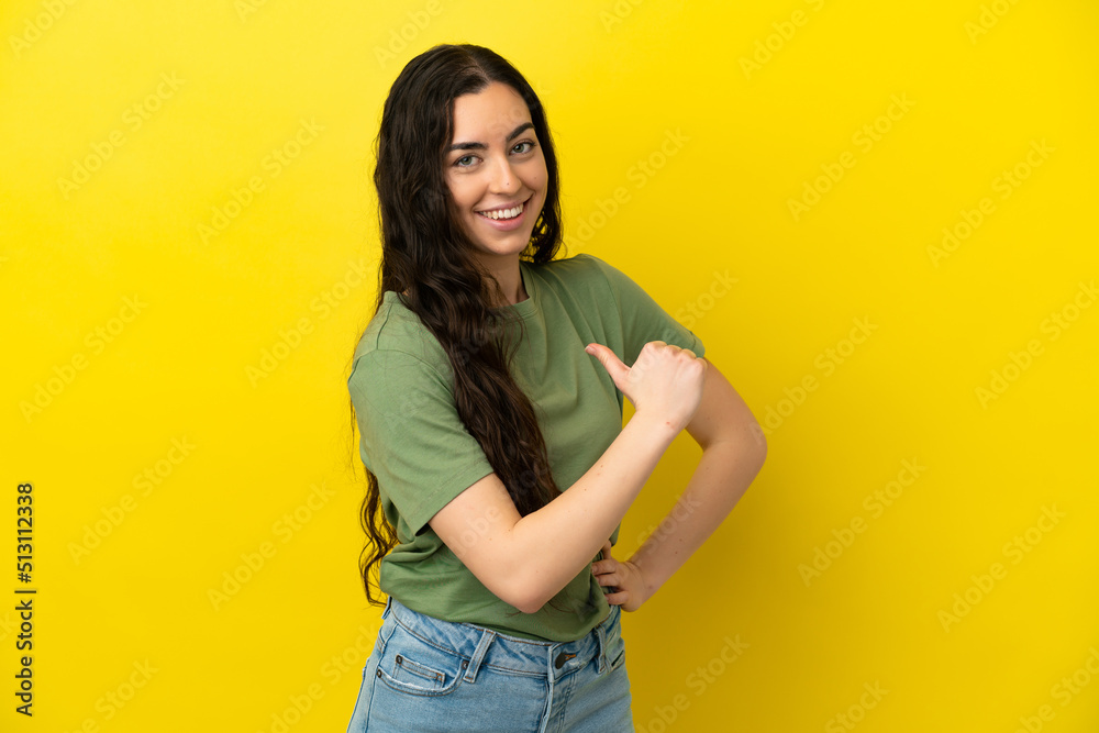 Young caucasian woman isolated on yellow background proud and self-satisfied Young caucasian woman isolated on yellow background proud and self-satisfied