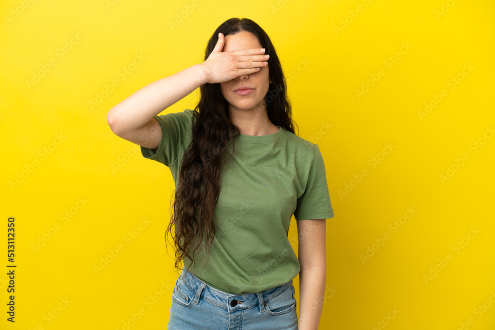 Young caucasian woman isolated on yellow background covering eyes by hands. Do not want to see something Young caucasian woman isolated on yellow background covering eyes by hands. Do not want to see something