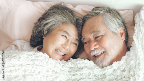Happy love Elderly couple smiling , Senior couple old man and senior woman relaxing in bed room - lifestyle senior concept