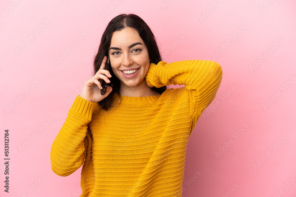 Young caucasian woman using mobile phone isolated on pink background laughing Young caucasian woman using mobile phone isolated on pink background laughing