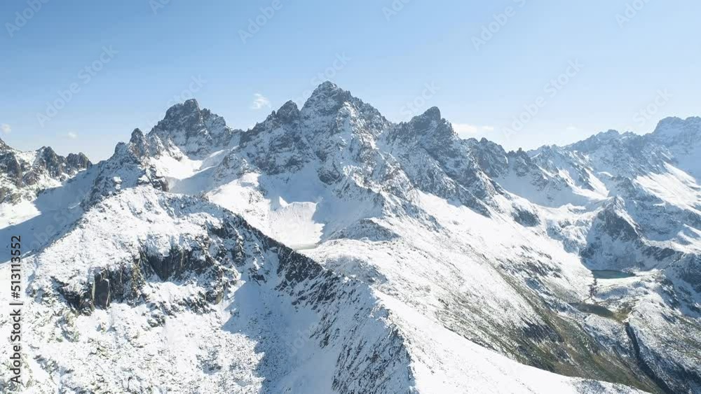 Snow-capped mountains with steep slopes. The lakes are in the high laite. Aerial view. Snow-capped mountains with steep slopes. The lakes are in the high laite. Aerial view.