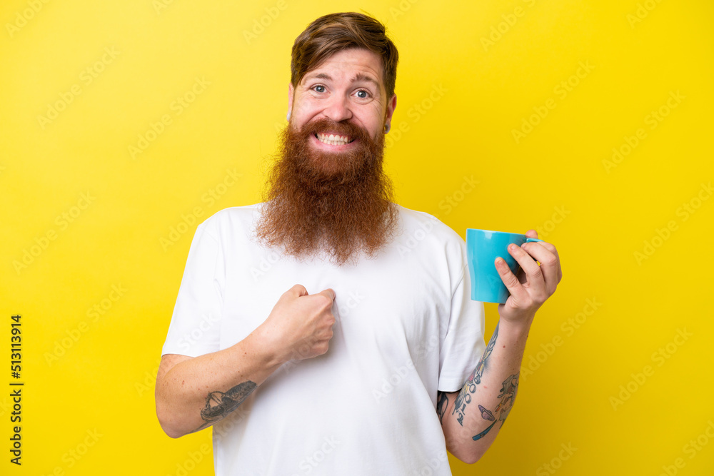 Redhead man with beard holding a mug isolated on yellow background with surprise facial expression Redhead man with beard holding a mug isolated on yellow background with surprise facial expression