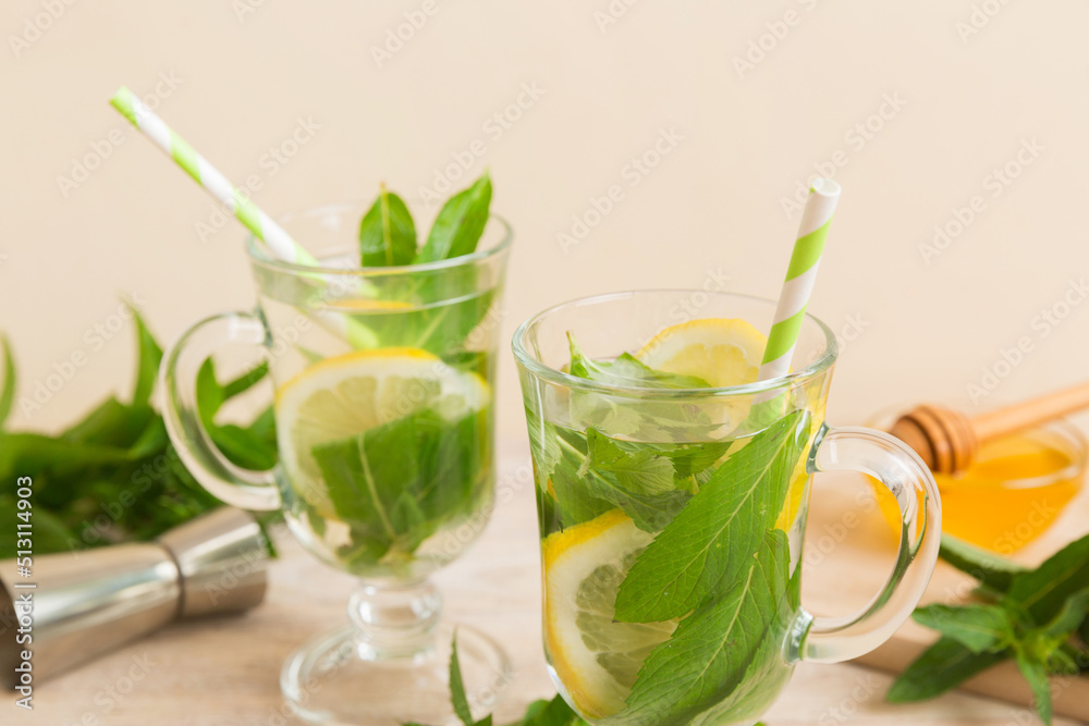 Mojito cocktail. Refreshing mojito cocktail with lime, lemon and mint in a tall glass with a stick Mojito cocktail. Refreshing mojito cocktail with lime, lemon and mint in a tall glass with a stick
