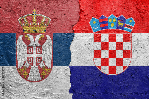 Serbia and Croatia - Cracked concrete wall painted with a Serbian flag on the left and a Croatian flag on the right stock photo