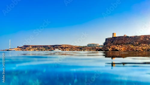 The view of Ghajn Tuffieha Bay in Malta, shot at the water's surface. photo