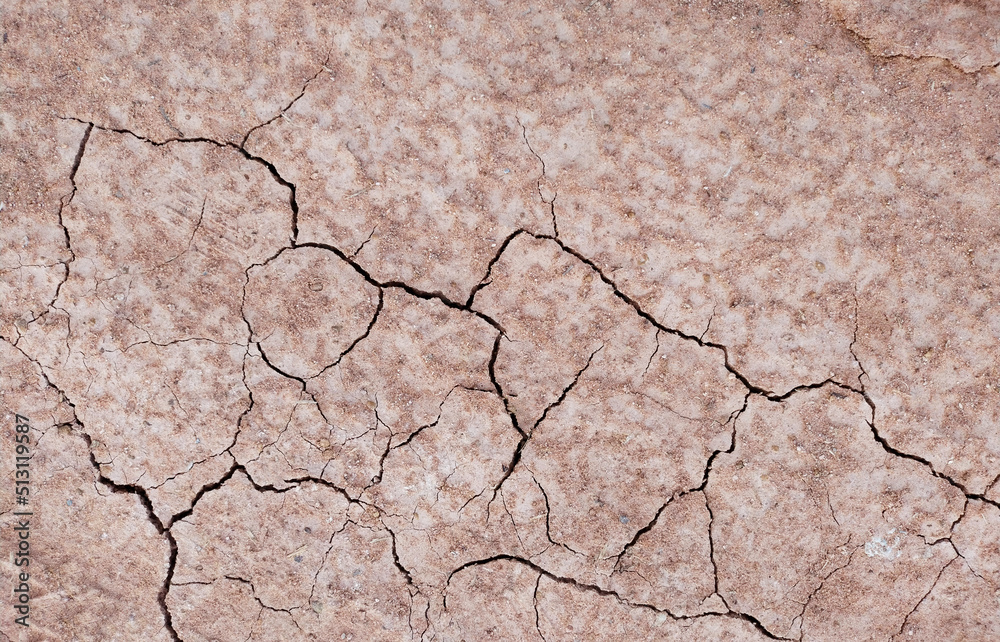 Obraz premium Cracked ground background in the top view for graphic design or wallpaper