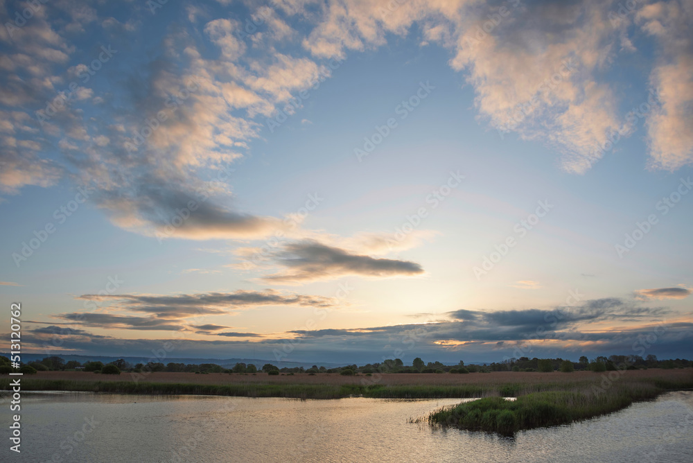 Stunning landscape sunset image of Somerset Levels wetlands in England during Spring