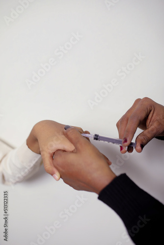 Doctor make an injection at home on white background. Medical and health care concept. 