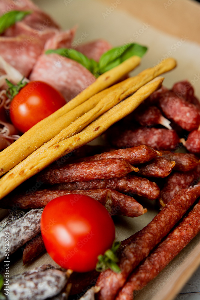 Italian sliced meat with bread and tomatoes