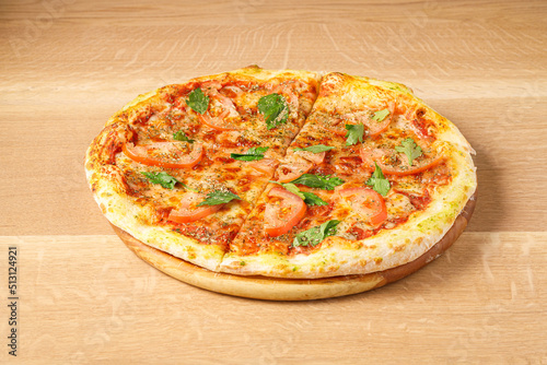 margarita pizza, on a light wooden background. photo