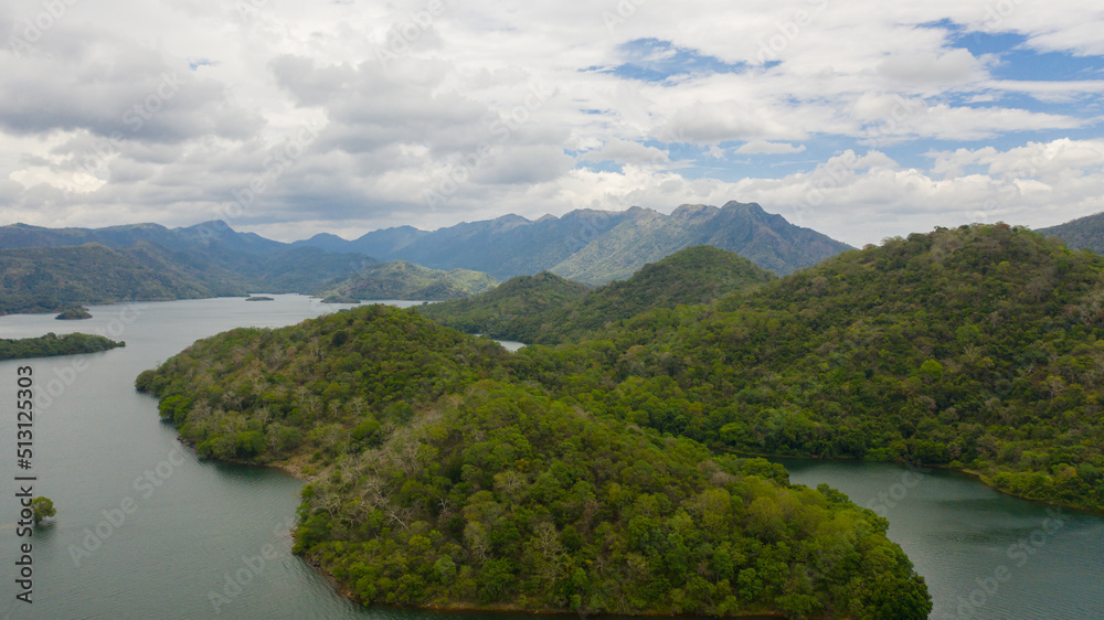Fototapeta premium Tropical landscape: A lake surrounded by mountains and jungle. Randenigala reservoir.