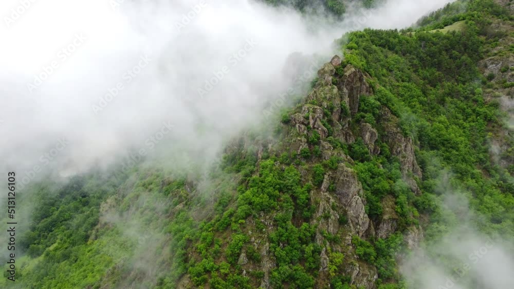Beautiful magical clouds in mountain forest. Rainy weather, Misty fog blowing over trees at morning aerial top view landscape Beautiful magical clouds in mountain forest. Rainy weather, Misty fog blowing over trees at morning aerial top view landscape