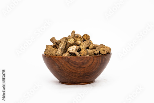 Ayurvedic herb or folk medicine Hemidesmus indicus or Nannari or Indian sarsaparilla dried roots in wooden bowl photo