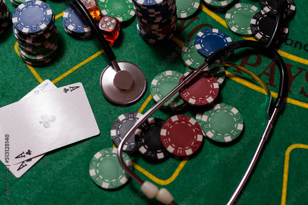 poker chips, money, stethoscope on blackjack table. poker chips, money, stethoscope on blackjack table.