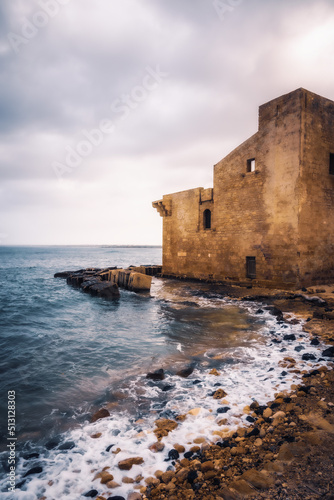East Coast of Sicily in Italy, Europe on a warm spring day at the coast with old structures