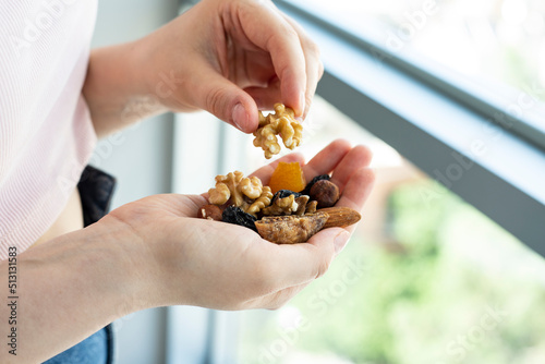 Close up shot of nuts in woman hands. Female holding healthy snacks