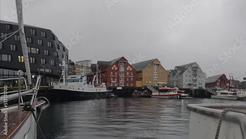 Fishing boat in port and harbour in Tromso. Embankment of the city of Tromso and it's marina, North Norway