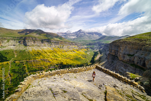 Woman hiking to the viewpoint of the Ordesa Valley in the Spanish Pyrenees. photo