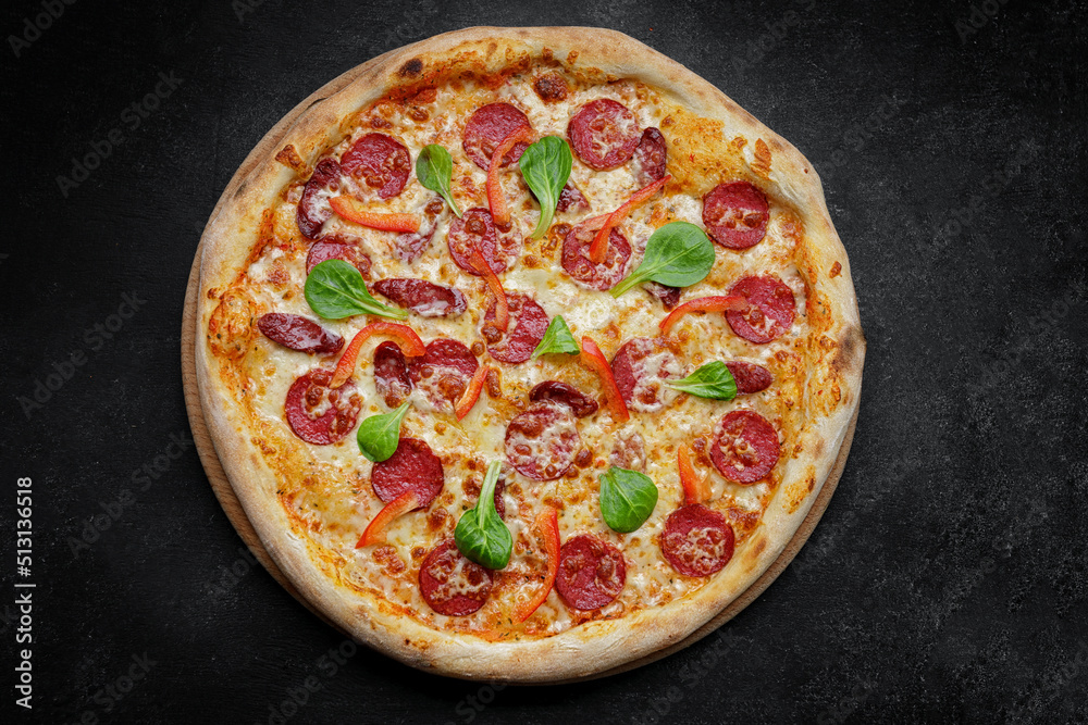 Pizza with sausage and bell pepper, close-up. studio light