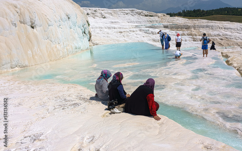 фотографія Unidentified women watch Pamukkale (Cotton Castle) known with its travertine terraces and health-giving pools with mineral water