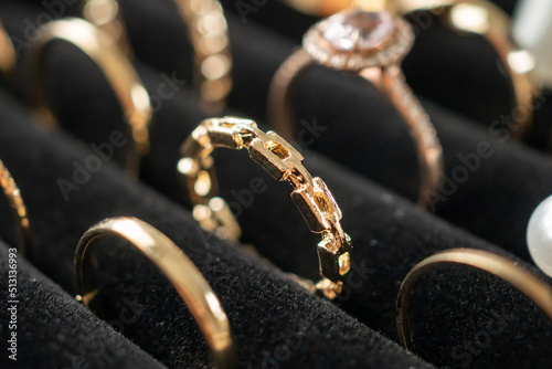 Gold jewelry diamond rings show in luxury retail store display showcase