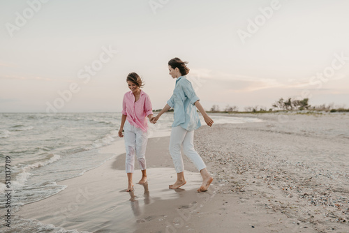 two young women having fun on the beach