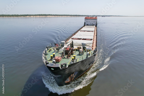 Cargo transportation. Cargo ship on the Volga River in front of the port with grain. Volgograd. Russia