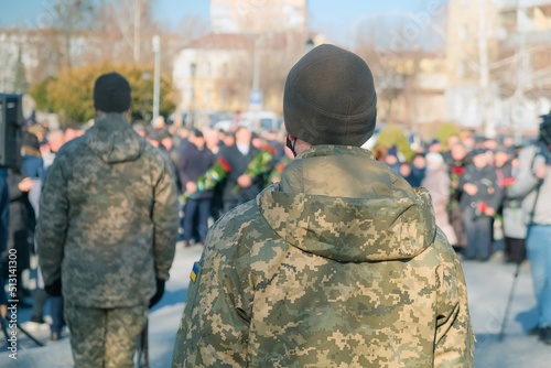 Armed forces squad patrol formation back view in military army uniform maintain public order and patrolling in the streets