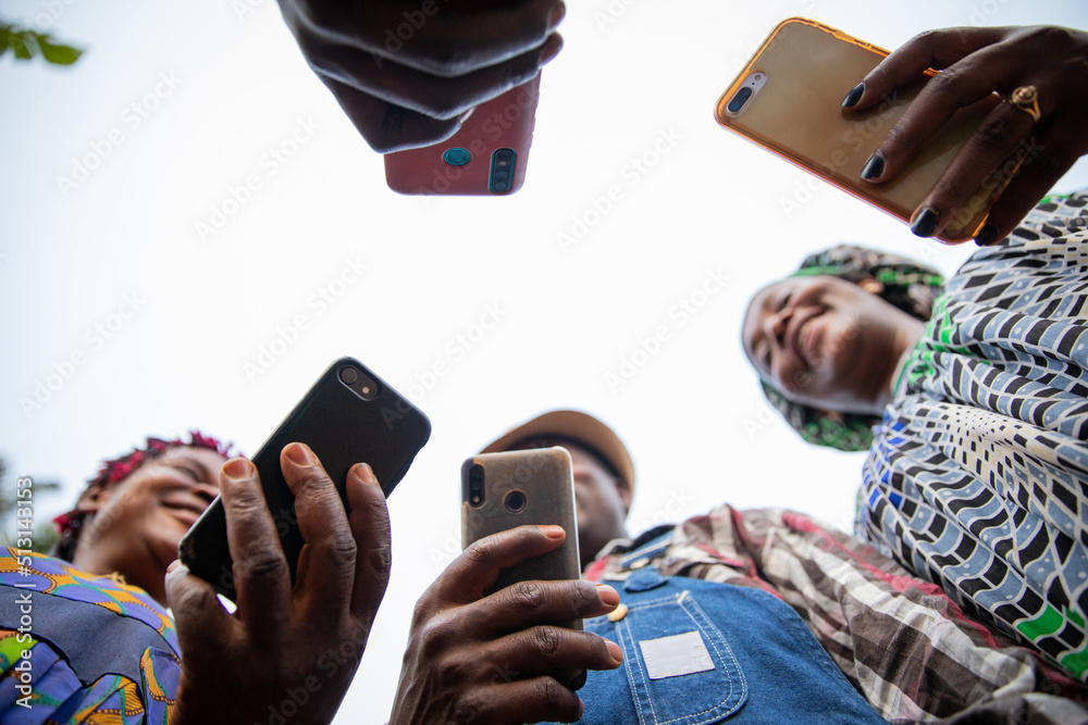 A group of african people use their smartphones, photos from below, technology and social networks in africa. - obrazy, fototapety, plakaty 