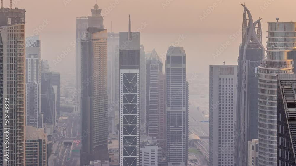 Downtown skyline with modern architecture form above timelapse. Aerial view of Dubai business bay towers. Hazy weather at evening Downtown skyline with modern architecture form above timelapse. Aerial view of Dubai business bay towers. Hazy weather at evening