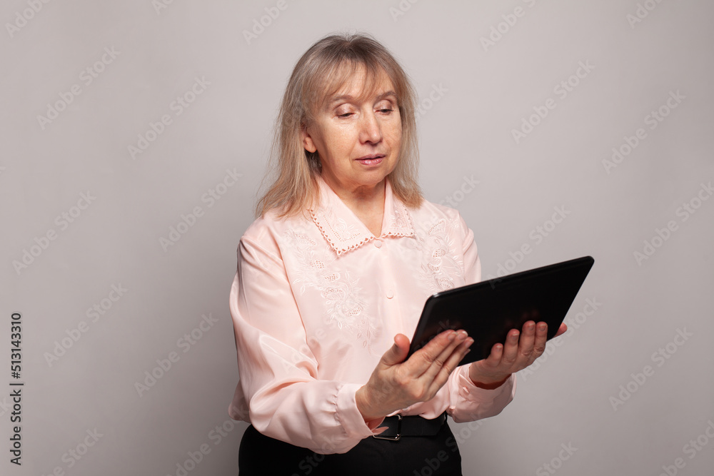 Mature adult woman using computer tablet Mature adult woman using computer tablet