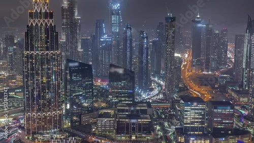 Wallpaper Mural Aerial view of tallest towers in Dubai Downtown skyline and highway night timelapse. Financial district and business area in smart urban city. Skyscraper and high-rise buildings Torontodigital.ca