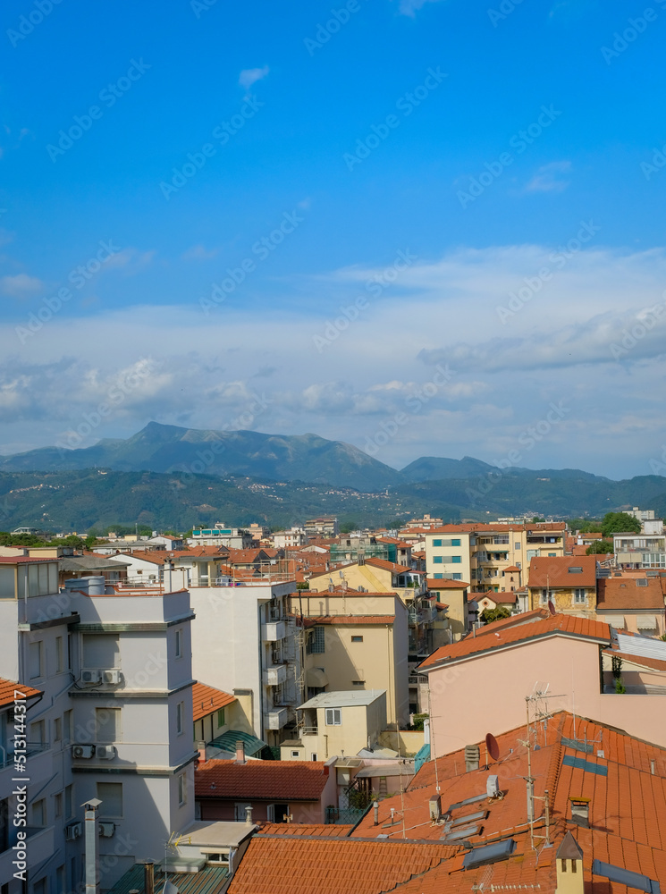 Rooftops of Viareggio with Italian Apennine mountains in the distance.