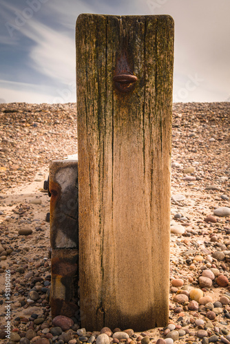 Valokuvatapetti A summer portrait HDR image of a wooden breakwater endpost with an eyebolt in on