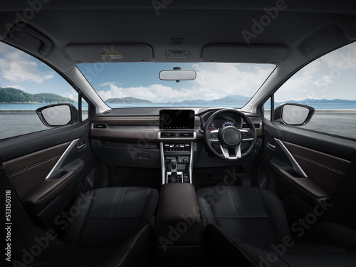 Inside the luxury car steering wheel, gear lever and dashboard.