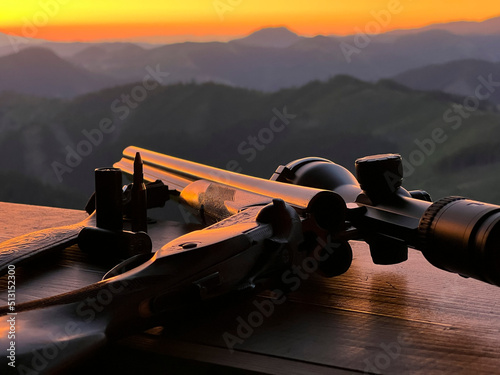 Close up of rifle  for  hunting. View from the window on sunrise.
