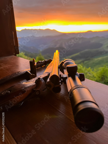 Close up of rifle  for  hunting. View from the window on sunrise.