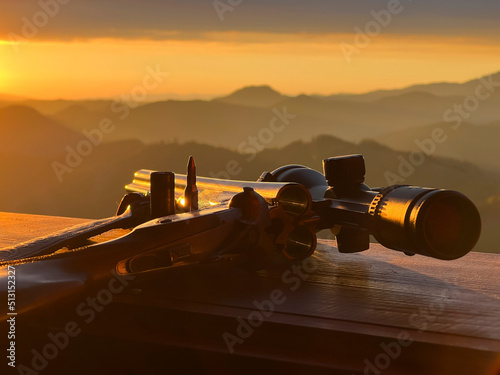 Close up of rifle  for  hunting. View from the window on sunrise.